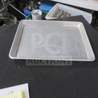 Aluminum 13x9.5 sheet pan in good condition. Smooth surface, slightly raised edges. 10XBID label visible.