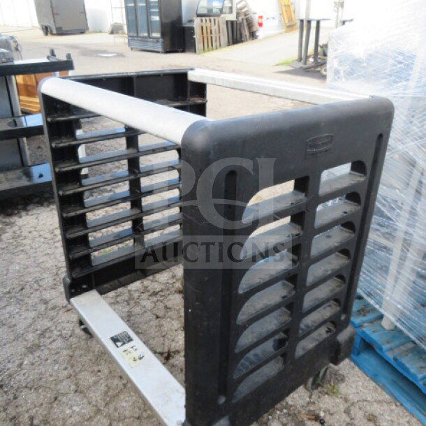 Rubbermaid 1/2 size pan rack on casters, 30x23x36 inches, black, tag indicates model, wear consistent with use.
