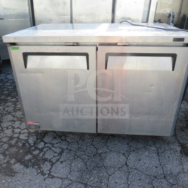 Turbo Air MUF-48N 2-door worktop freezer with 2 racks, on casters, stainless steel, measures 48x30x35 inches, good condition.