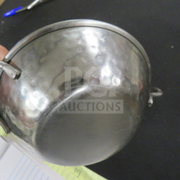 Stainless steel hammered bowl, 5.5 inches, with handles. Polished finish, slight wear. Model 10XBID, $7.79 each.