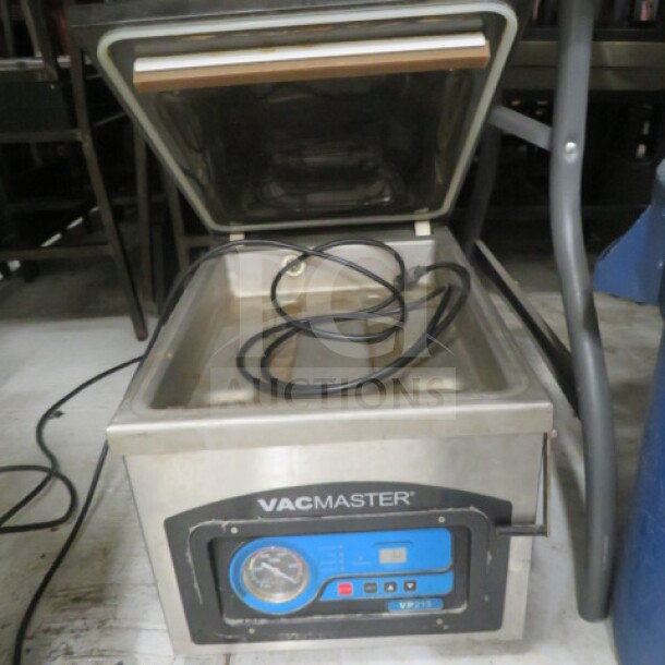 Vac Master VP215 vacuum sealer, stainless steel, open lid, intact control panel, coiled hose, price $1069.00.