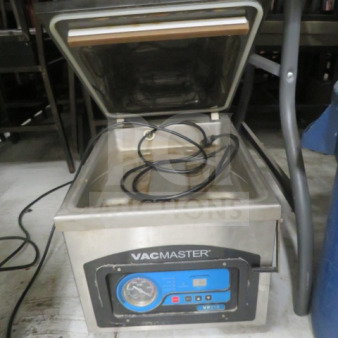 Vac Master VP215 vacuum sealer, stainless steel, open lid, intact control panel, coiled hose, price $1069.00.