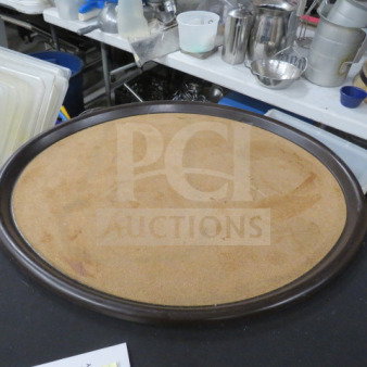 Oval wooden serving tray, 28x23 inches, with a brown finish. Shows signs of wear and use.