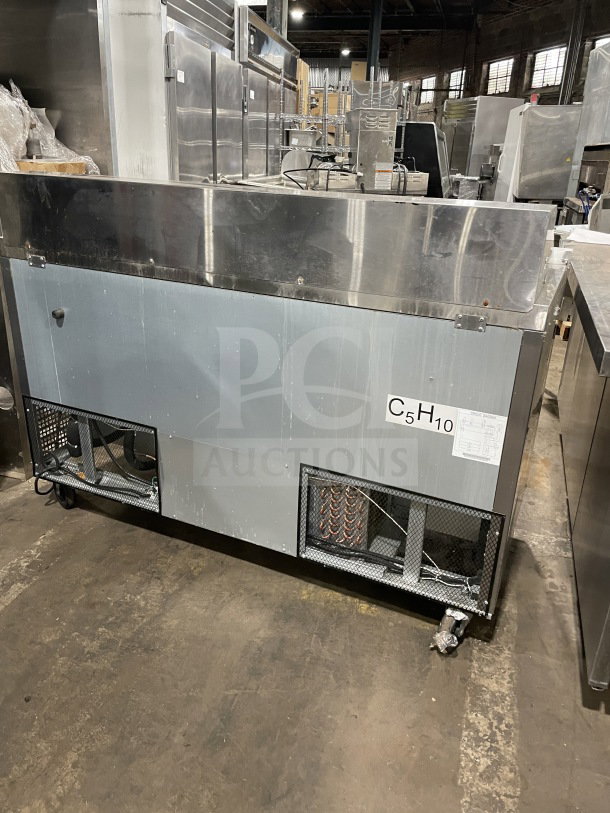 Berg 60" stainless steel 2-door prep table, model BERGS60, with poly-coated wired rack. Commercial-grade, good condition.