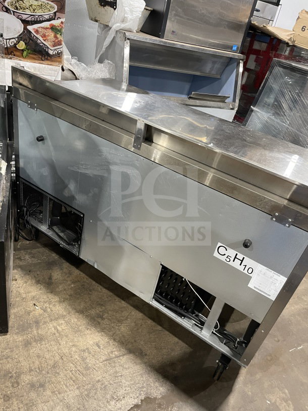 Berg BERWT60R 60" stainless steel 2-door prep table with poly-coated rack, used condition, functional, model tag visible.