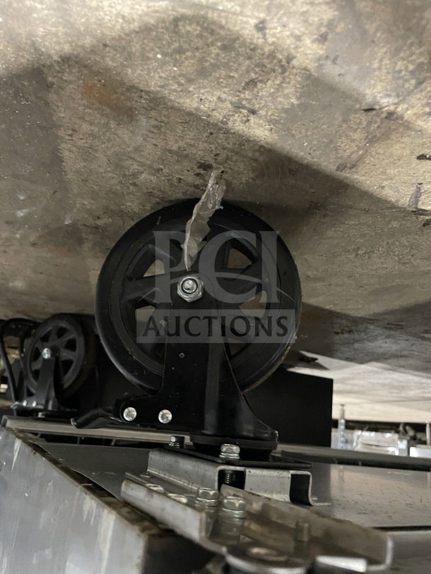Wheels of Berg BERWT60R prep table, showing underside and wheel attachments, indicating mobility and durability.
