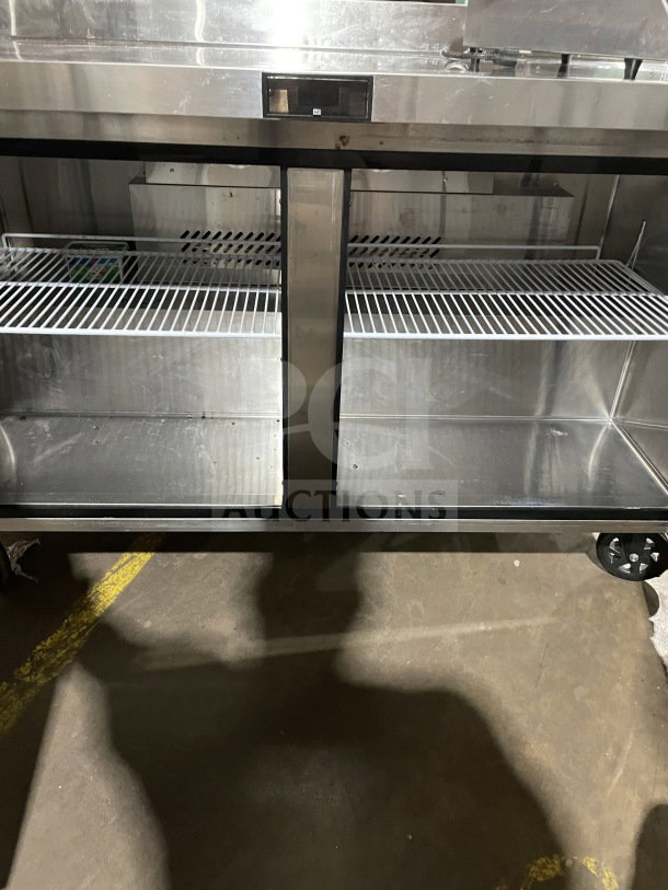 Berg 60" stainless steel 2-door prep table, model BERWT60R. Features poly-coated wire rack. In working condition.