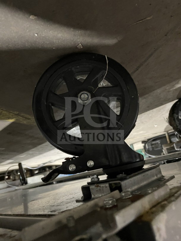 Close-up of the wheel on a Berg Commercial Stainless Steel 60" Sandwich & Salad Prep Table, Model BERWT60R.