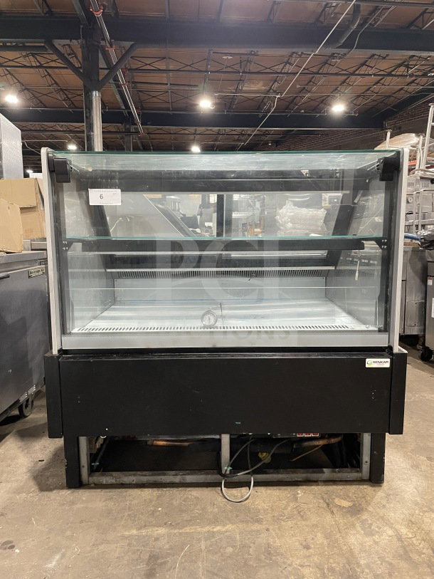 Commercial refrigerated display case with glass front and shelves, black exterior, working condition, NENKLAR logo.