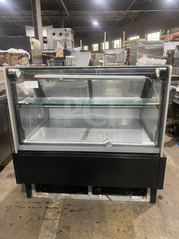 Commercial glass display refrigerator, black frame, double-layered shelves, visible wear on base, auction tag labeled "7".