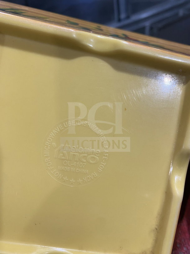Detailed view of a yellow melamine specialty plate by Yanco, model OL-4107. Marked dishwasher and microwave safe. Made in China.