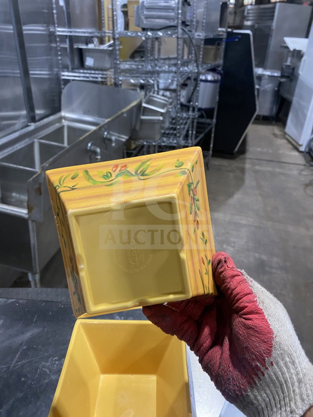 Square geometric melamine deep bowls, vibrant yellow with floral pattern, sturdy design. Markings indicate durability and quality.