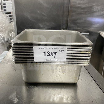 Stack of commercial stainless steel half-size hotel food pans. Condition: used. Label shows "13X9 QTY".
