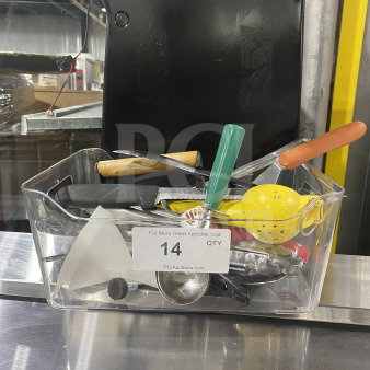 Clear container holding assorted commercial kitchen smallwares and prep utensils, including a scoop, lemon squeezer, and various handles. Auction tag "14 QTY" visible.