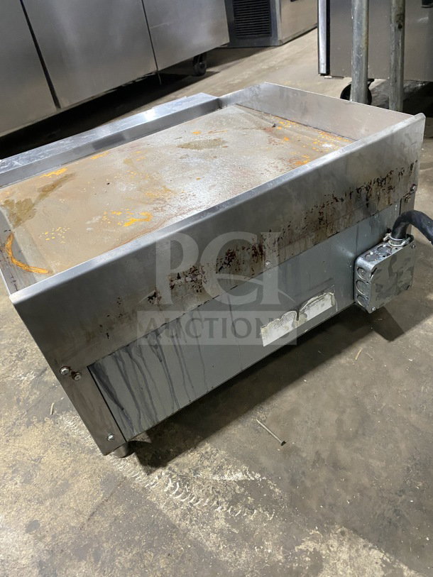 2024 Patriot Platinum Series stainless steel flat top electric grill, model PTG24E, with visible rust, on legs.
