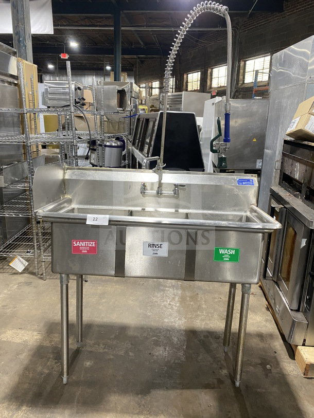 L&J stainless steel 3-bay dishwashing sink with wash, rinse, sanitize labels and dual drain boards on legs.