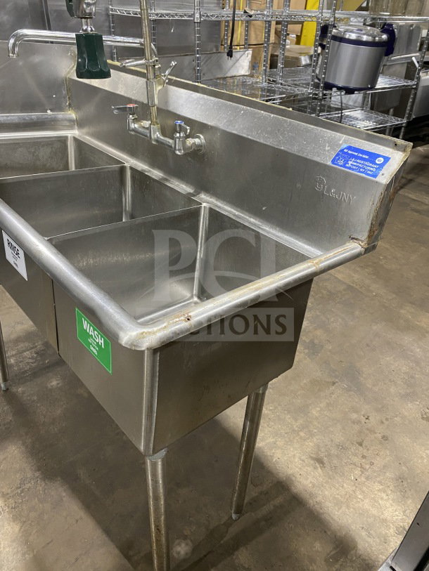 L&J Stainless Steel 3-bay commercial sink with dual drain boards. Features wash, rinse, sanitize bays. In good condition.