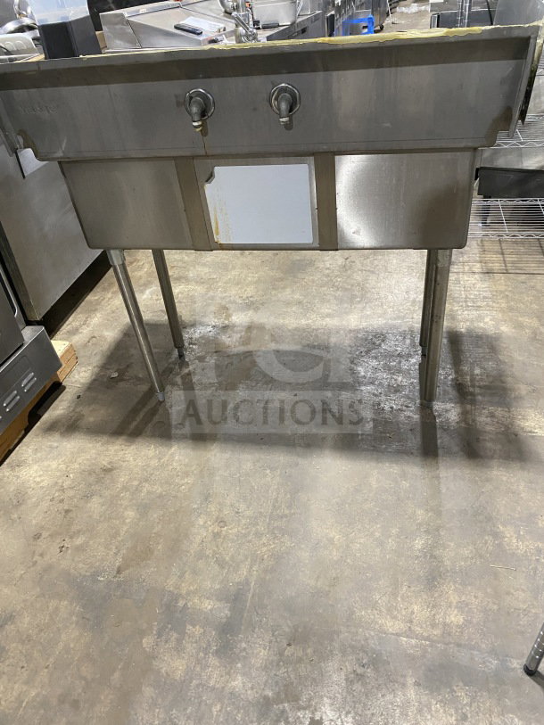 L&J stainless steel 3-bay dishwashing sink with dual drain boards, commercial-grade, mounted on legs, slightly used condition.