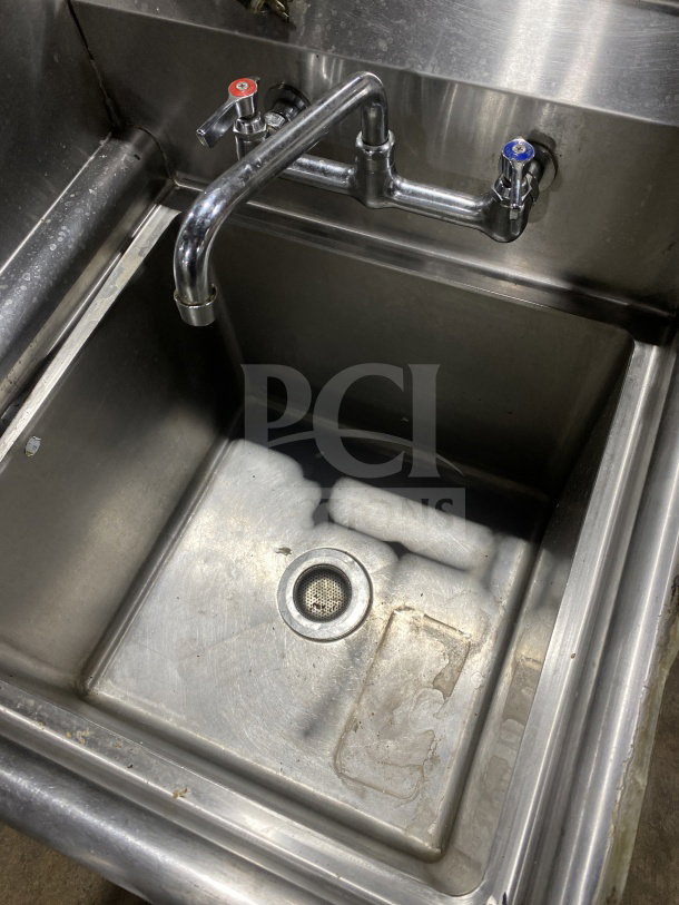 KCS stainless steel prep sink with integrated garbage disposal, splash-mount faucet, and sturdy legs. Clean condition.