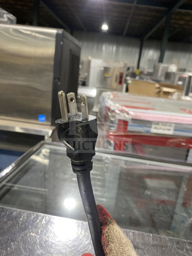 Waring Commercial WCT800 toaster power cord detail in warehouse setting, showcasing a three-pronged plug.