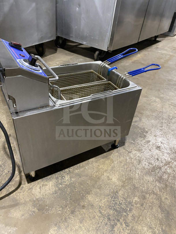 Globe PF16E stainless steel countertop electric deep fryer, 2024 model, with frying basket and backsplash, on legs, 208/240V.