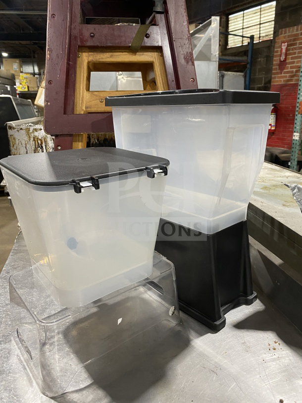Commercial plastic cold beverage dispenser combo, two clear reservoirs, black lids, sturdy bases, used condition.