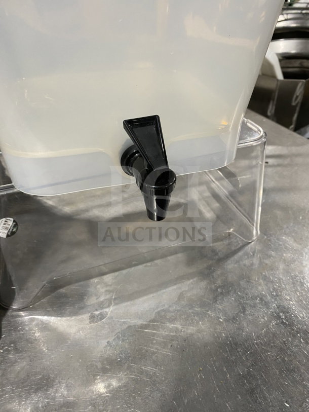 Commercial beverage dispenser combo with spigot, clear plastic reservoir, in good condition.