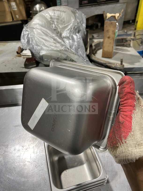 Winco SPJL604 half-size stainless steel anti-jam pan in good condition. Features visible logo and model number on the base.