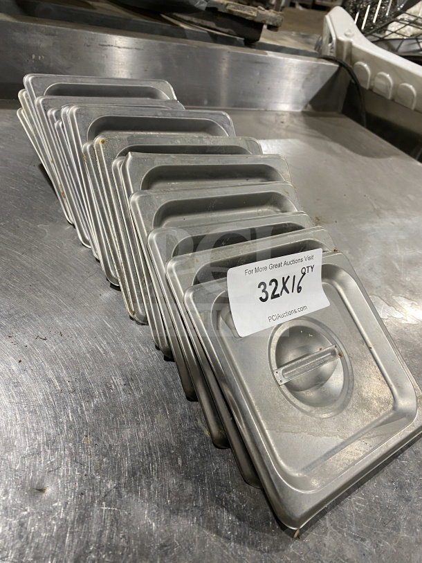 Winco SPSCS stainless steel 1/6 pan lids, auction lot of 16. Visible condition shows light wear. Label indicates quantity.