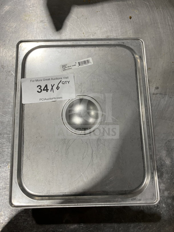 Winco SPSCH half-size steam table pan cover, stainless steel, with center handle. Model tag visible. Light surface scratches.