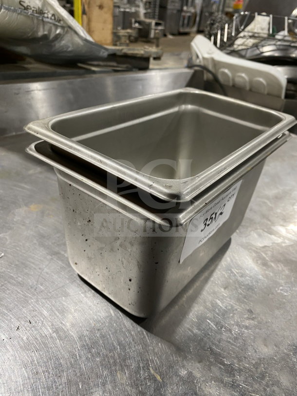 Winco SPJM406 quarter-size steam pan; stainless steel; commercial use; visible label; shows signs of use; bid opportunity.