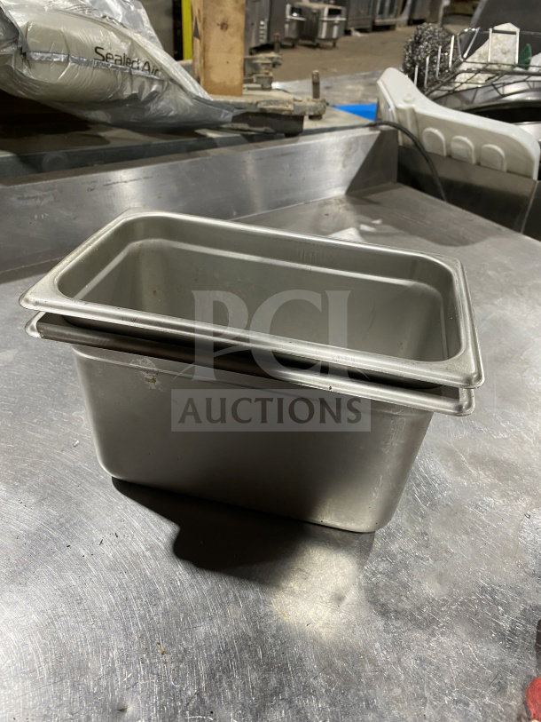 Winco SPJM406 stainless steel quarter-size steam pan in excellent condition on a metal countertop.