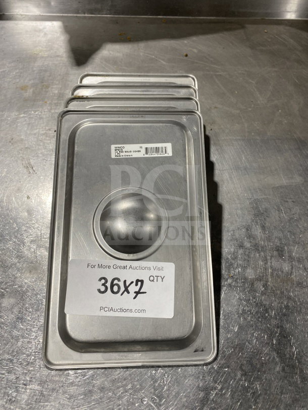 Winco stainless steel 1/4-size steam table pan cover, model SPSCQ, with recessed handle and visible barcode label.