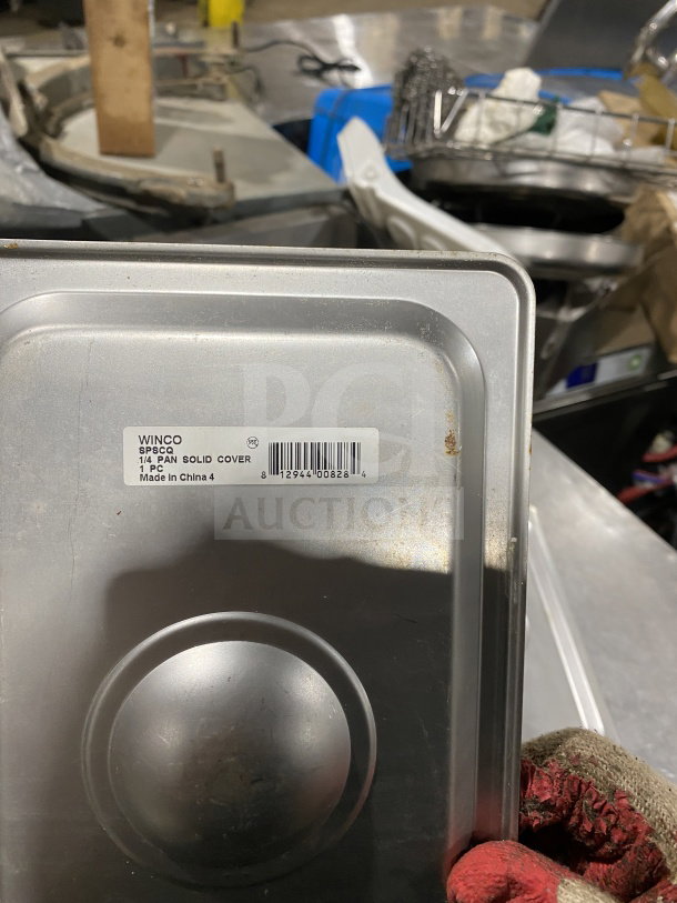 Winco stainless steel 1/4-size steam table pan cover, model SPSCQ, recessed handle, visible label. Good condition.