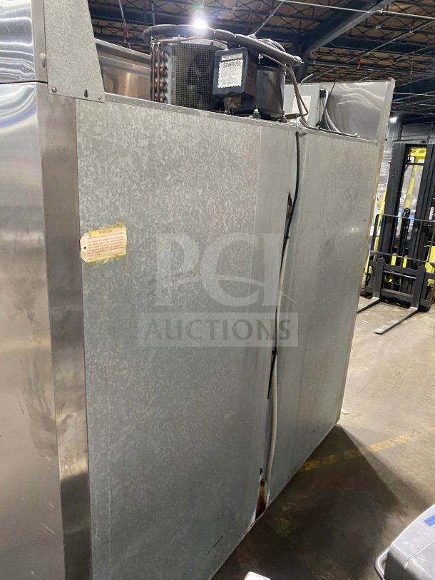 Glenco XL Series EB 3-Door Stainless Steel Refrigerator, Model SLS74TE, with chrome-plated wire rack, 115V, shown in a warehouse.