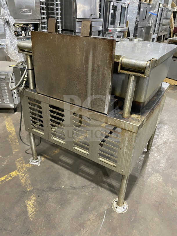 Crown GS-30 stainless steel 30-gallon natural gas steam tilt skillet, open base, strainer, measurement marks, on legs, used.