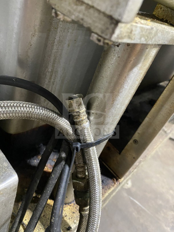 Crown GS-30 stainless steel steam tilt skillet, natural gas powered, 30 gal capacity, visible hoses and brackets, natural wear.