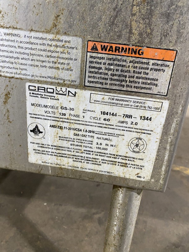 Crown GS-30 stainless steel steam tilt skillet, 30 gal, natural gas, open base, 120V, 1-phase, model and warning labels visible.