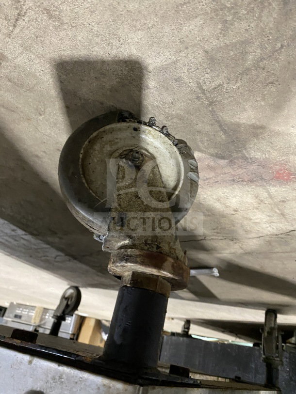 Blodgett commercial double-stacked convection oven caster. Rust visible, suggests wear. Image shows underside detail.