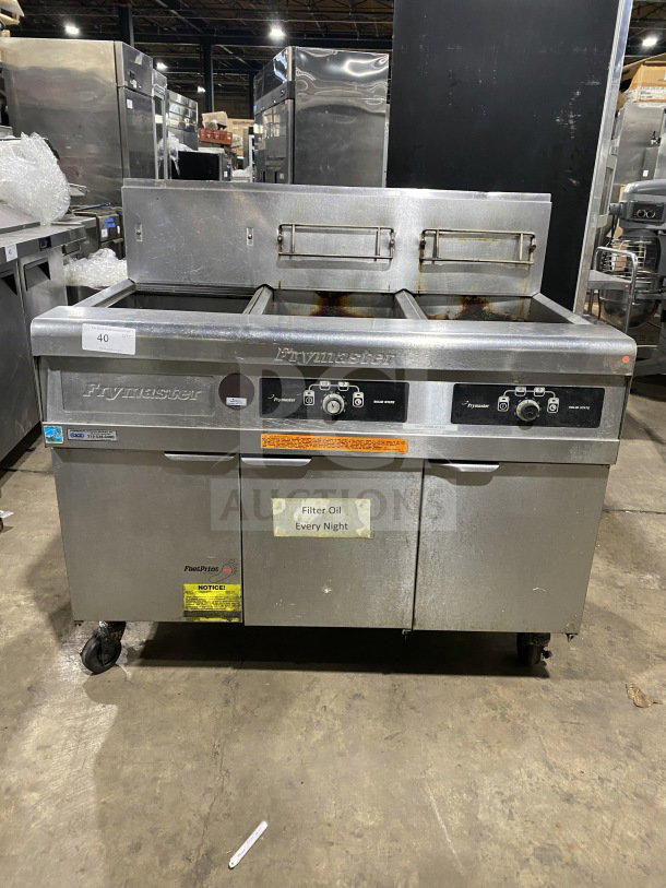 Frymaster FMPH255SC commercial stainless steel dual deep fryer with backsplash, filter system, left dump station, on casters.