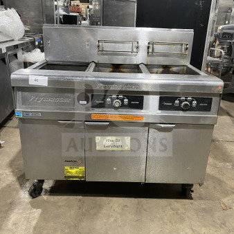 Frymaster FMPH255SC commercial stainless steel dual deep fryer with backsplash, filter system, left dump station, on casters.
