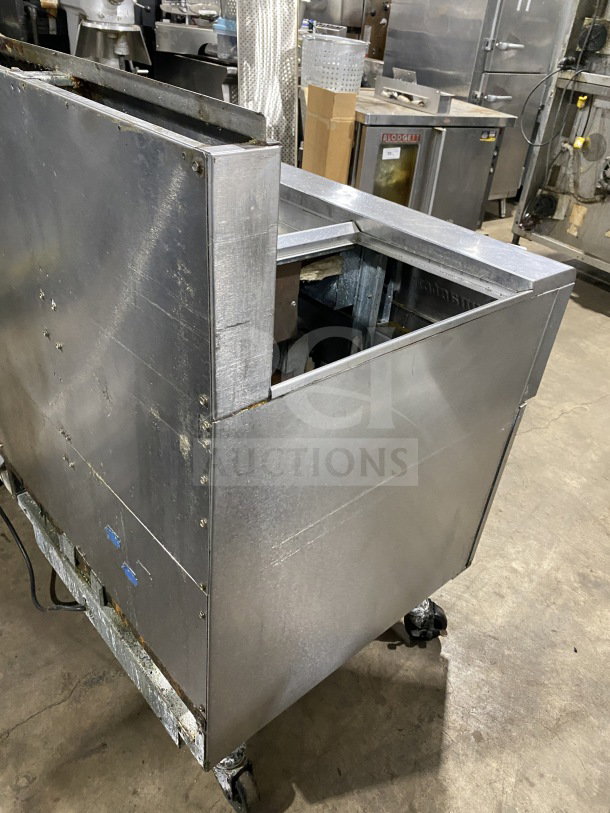 Frymaster FMPH255SC commercial dual deep fat fryer, stainless steel, natural gas, with dumping station, filter, backsplash, on casters.