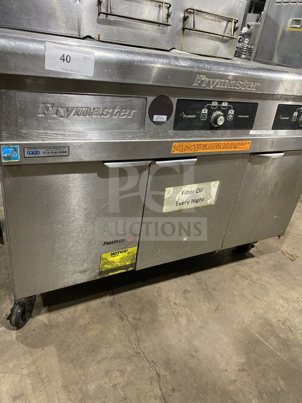 Frymaster FMPH255SC stainless steel dual deep fat fryer with natural gas, left side dumping station, backsplash, filter system, on casters.