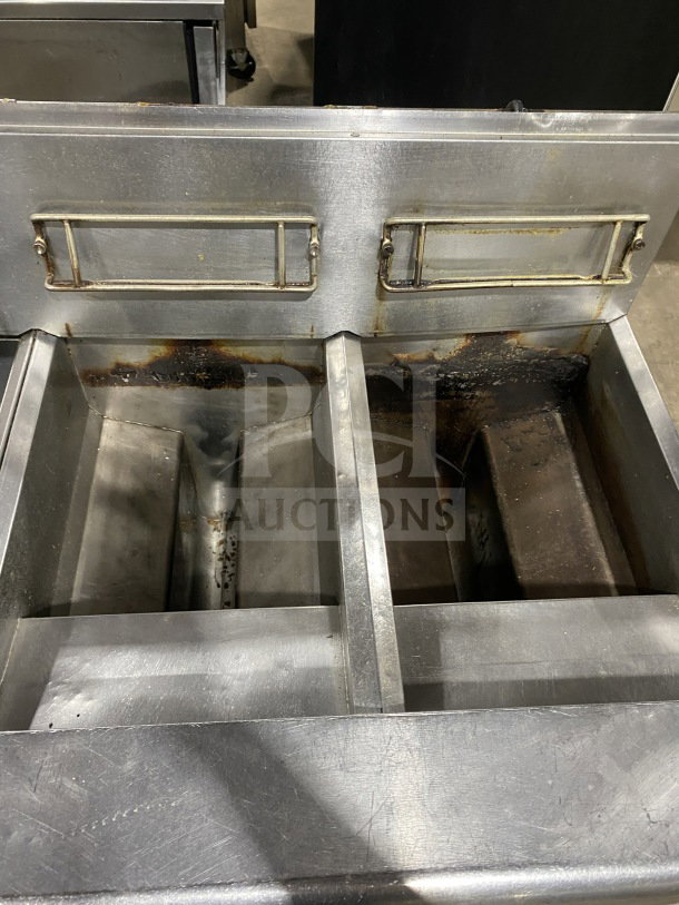 Frymaster FMPH255SC commercial stainless steel dual deep fryer with left-side dumping station, backsplash, and filter system on casters.