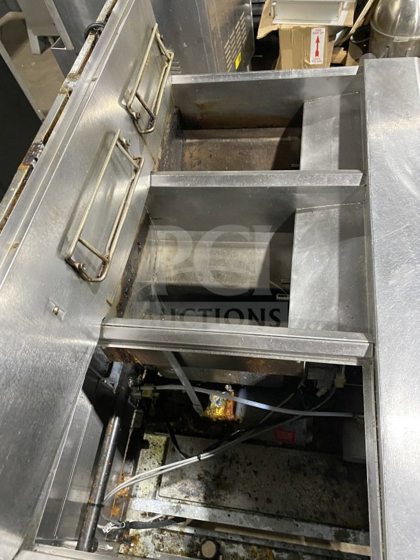 Frymaster FMPH255SC commercial stainless steel dual deep fryer with left dumping station, backsplash, filter system, on casters.