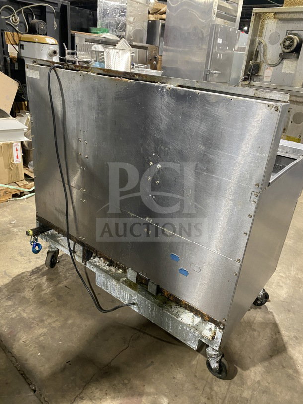 Frymaster FMPH255SC commercial stainless steel natural gas fryer with left dumping station, backsplash, filter system, on casters.