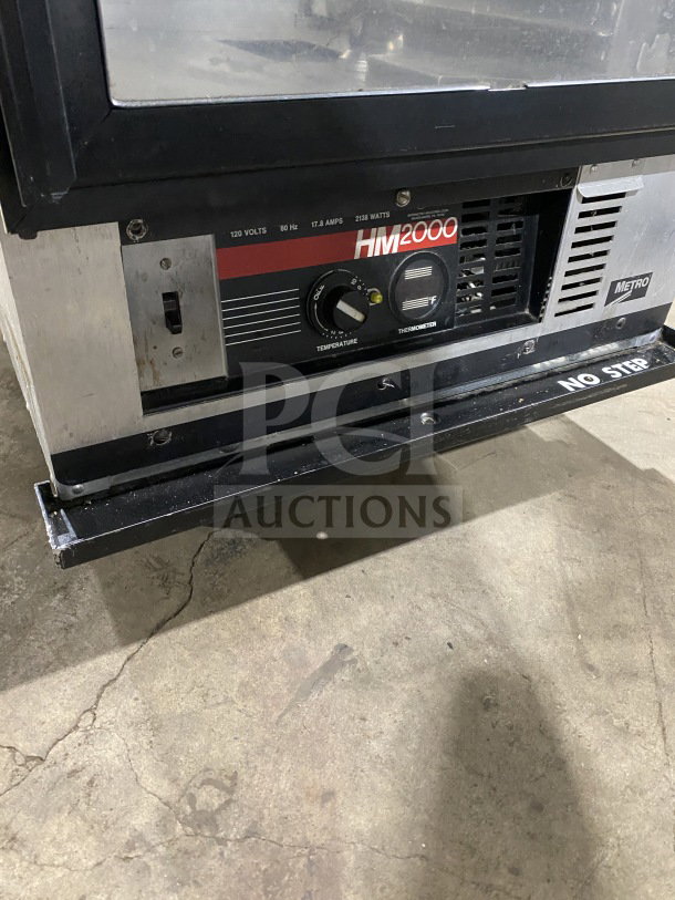 Metro H2 2000 Series stainless steel heated holding cabinet, model C175HM2000. Features glass door, control panel, on legs.