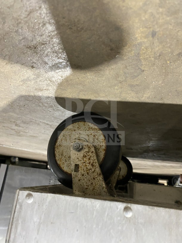 Wheel and bottom view of Metro H2 2000 Series stainless steel heated holding cabinet, Model C175HM2000, showing signs of rust.