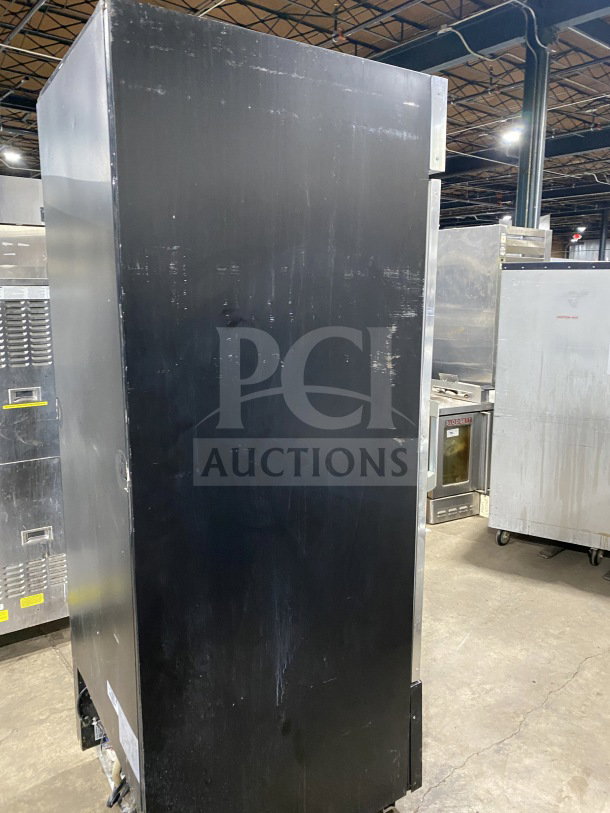 Kelvinator Commercial display freezer, model KCGM24FB, with swinging door, bottom mount compressor, on casters.