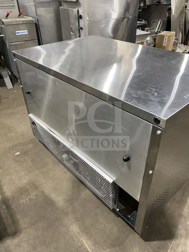 True TUC-48F-D-4-HC stainless steel 4-drawer undercounter freezer with marble style worktop, upturned back/splash, on casters.